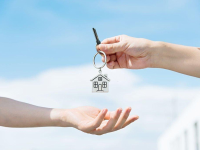 Handing over the house keys from one person to another.